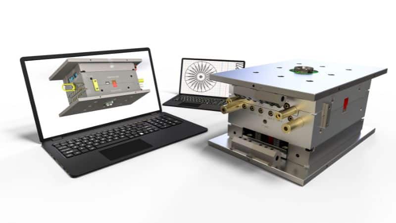 CAD-ohjelmisto kannettavalla tietokoneella ja prototyyppivalumuotti.