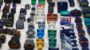 Assorted plastic injection molded electronic connectors and parts used in electronics production, showcasing precision molding techniques.