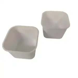Two white plastic containers with square shapes, suitable for storage or organization purposes.