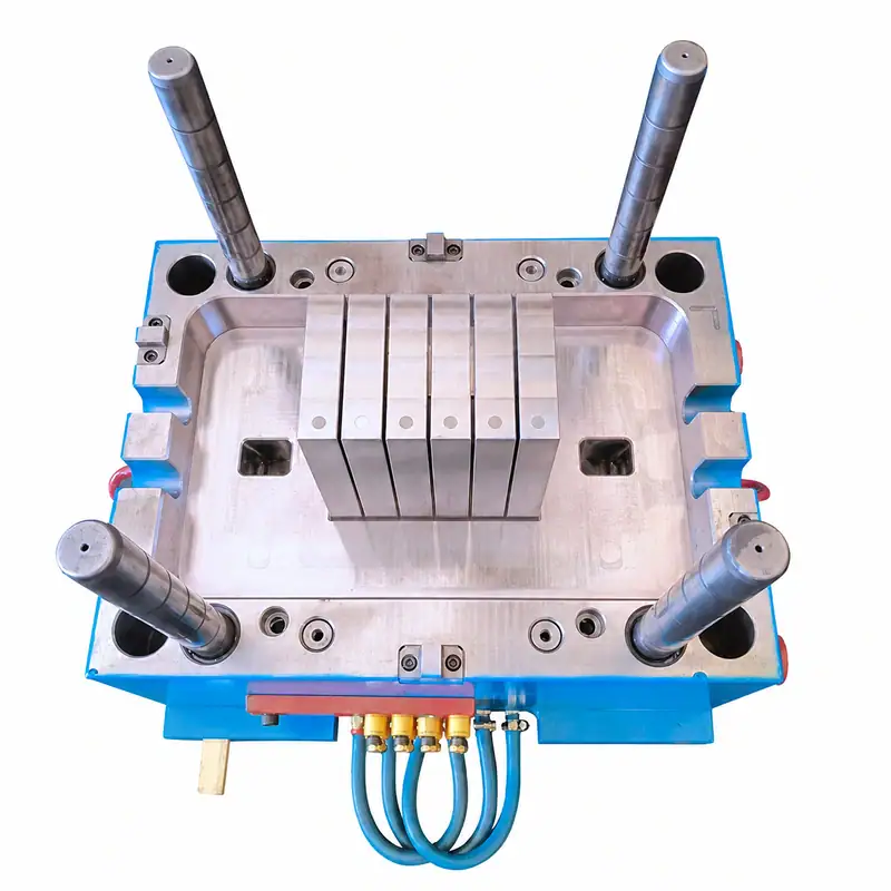 Injection mold for plastic battery box with multiple cylindrical pins and cooling channels, used in manufacturing battery enclosures.