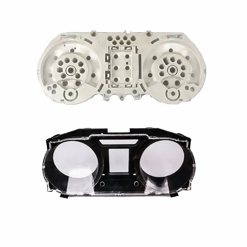 Injection mold for automotive dashboard instrument cluster with detailed cavities for gauges and display.