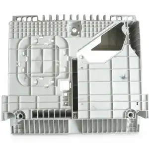 Close-up of a white plastic electronic enclosure with multiple compartments and mounting points, used for housing electronic components.