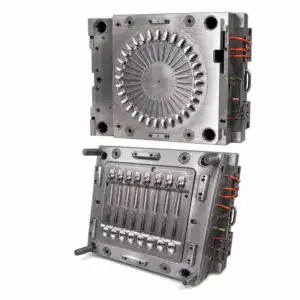 Close-up of precision metal mold die components used in manufacturing processes, showcasing detailed cavities and metallic finish.