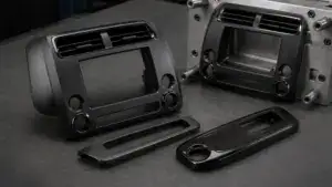 Close-up of an injection molding machine with multiple molds ready for processing, highlighting surface finishes and secondary treatments for molded parts.